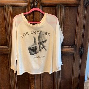 Long sleeve top with sheer sleeves and open back.